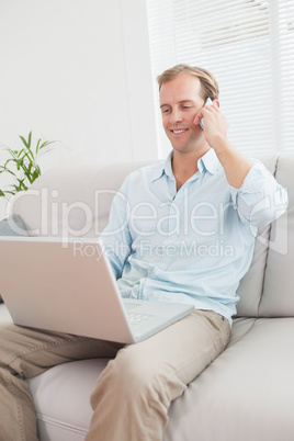 Casual man using laptop on the couch