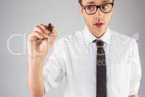 Geeky businessman writing with marker