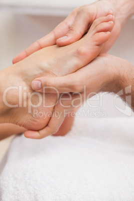 Pedicurist massaging a customers feet