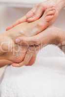Pedicurist massaging a customers feet