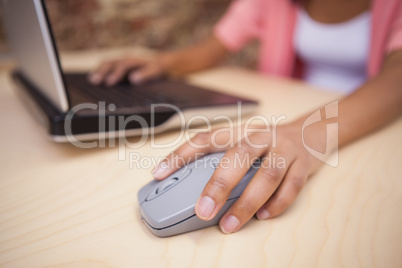 Close up of a hand using a grey mouse