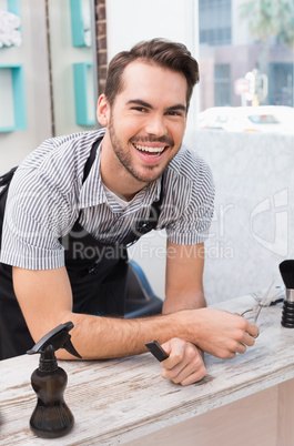 Handsome hair stylist smiling at camera