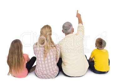 Happy family sitting and pointing