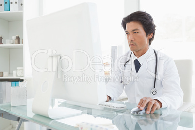 Serious doctor using the computer