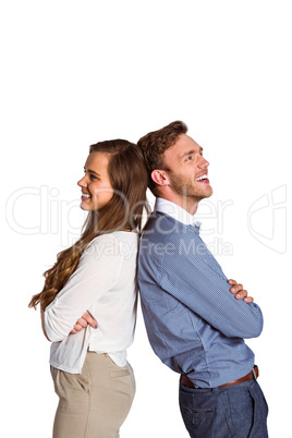 Happy young couple standing back to back