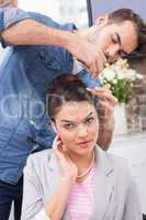 Pretty brunette getting her hair styled