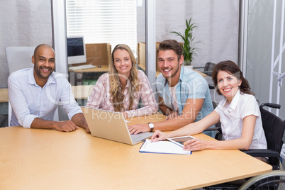 Group of business people using tablet computer and laptop
