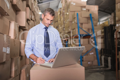 Concentrated warehouse manager using laptop