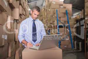 Concentrated warehouse manager using laptop