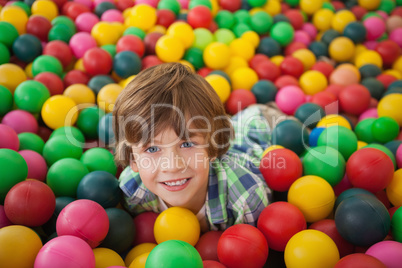 Cute boy smiling in ball pool