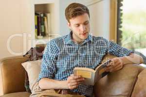 Young man reading on his couch