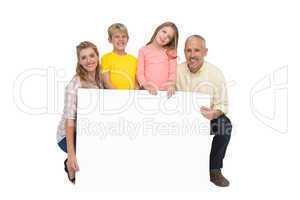 Happy family showing white card