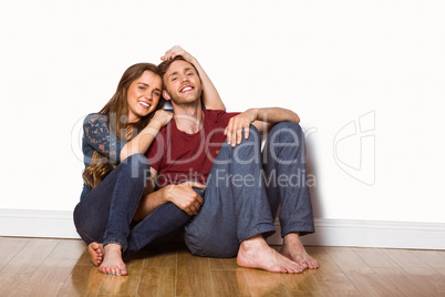 Young couple sitting on floor