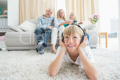 Little boy listening to music on the floor