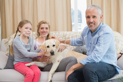 Parents and daughter with pet labrador