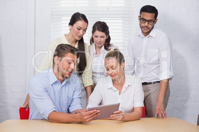 Business people using digital tablet in meeting