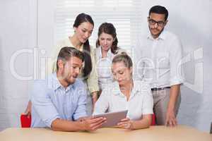 Business people using digital tablet in meeting