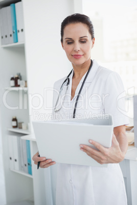 Focused doctor looking at a folder