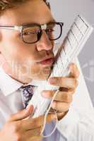 Geeky businessman kissing his keyboard