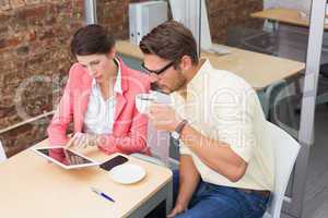 Business colleagues holding coffee cup and digital tablet