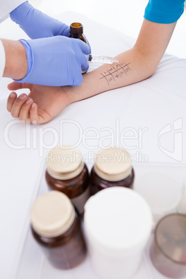 Doctor doing skin prick test at his patient