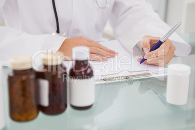 Vet writing on clipboard the prescriptions