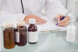 Vet writing on clipboard the prescriptions