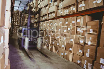 Forklift in large warehouse