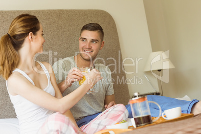 Cute couple having breakfast in bed
