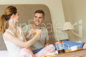 Cute couple having breakfast in bed