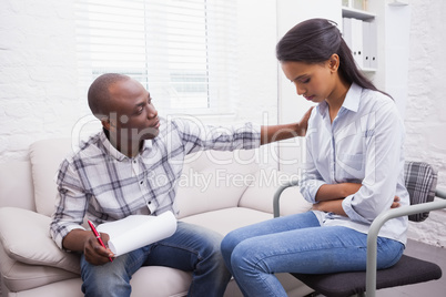 Worried woman being comforted by her therapist