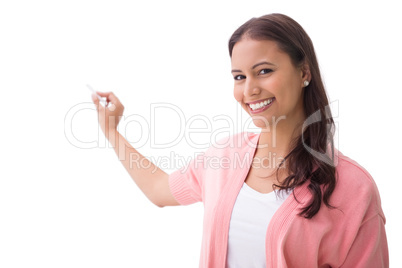 Pretty brunette smiling and writing