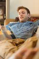 Young man reading on his couch