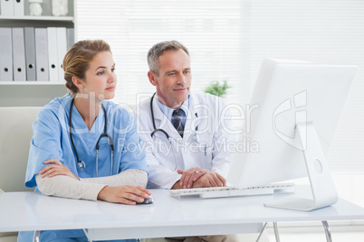 Medical workers looking at a computer