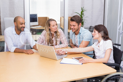 Group of business people using tablet computer and laptop