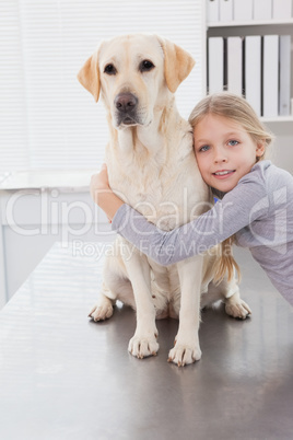 Blonde owner hugging her cute dog