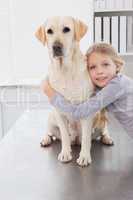 Blonde owner hugging her cute dog