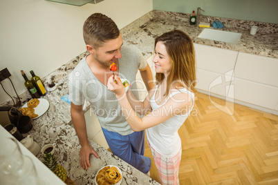 Couple eating fruit salad at breakfast