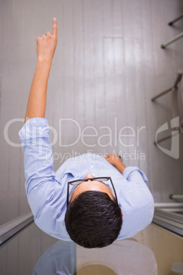 Businessman pointing away in office