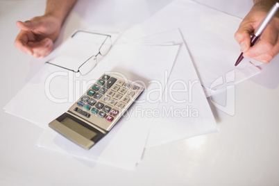 Bills and calculator on table