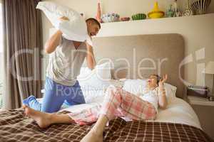 Cute couple having a pillow fight