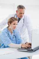 Nurse and doctor working on a laptop