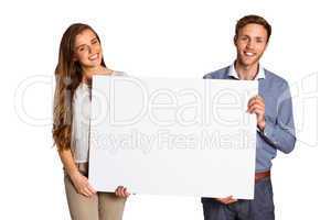 Happy young couple with blank board