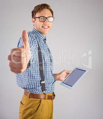 Geeky businessman using his tablet pc