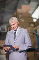 Male manager using digital tablet
