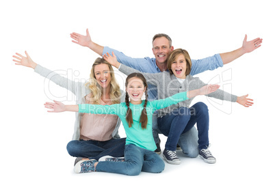 Cheering family with two children sitting on the floor