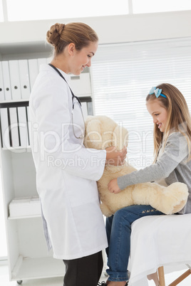 Doctor giving a patient a stuffed bear