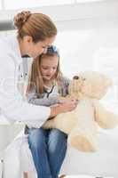 Doctor giving a patient a stuffed bear