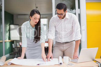 Casual architecture team working together at desk