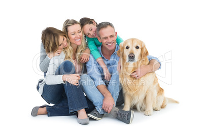 Portrait of smiling family sitting together with their dog